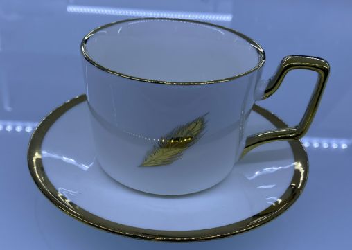 Coffee cup and saucer with a gold leaf