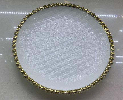 White plate with a beaded rim