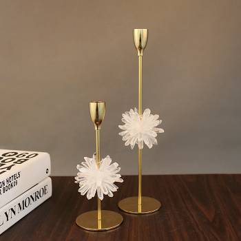 Gold candlesticks with white flowers