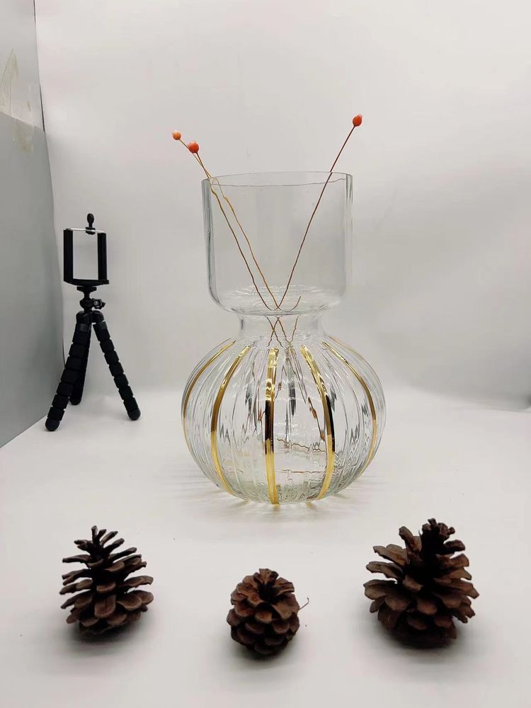 Clear glass vase with a gold band