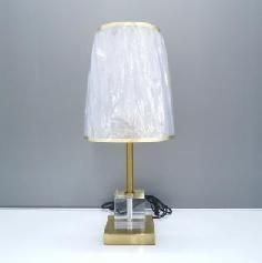 Table lamp with a pleated shade and clear base