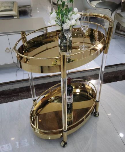 Gold oval serving cart with clear legs